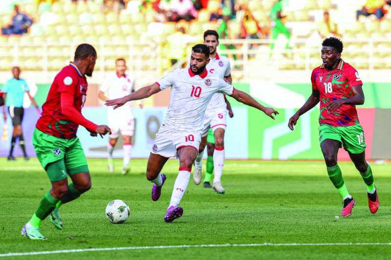 


أنيس بن سليمان مسدداً الكرة بين لاعبي ناميبيا                  	              (أ ف ب) 